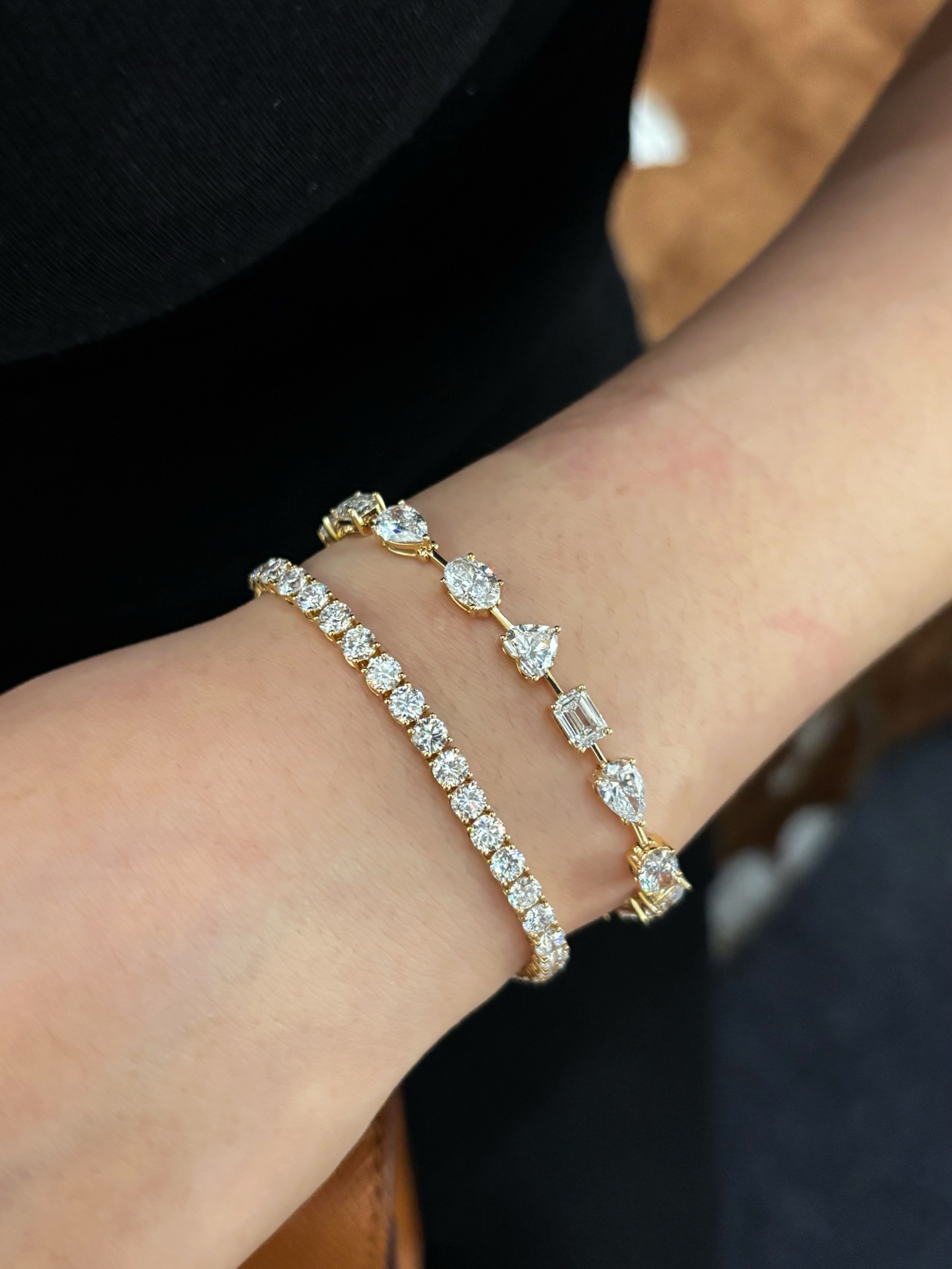 Real wearing photograph of round and mixed-shape bracelets, shown together