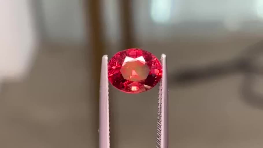 Red gemstone held in tweezers, first frame of the supplied original film