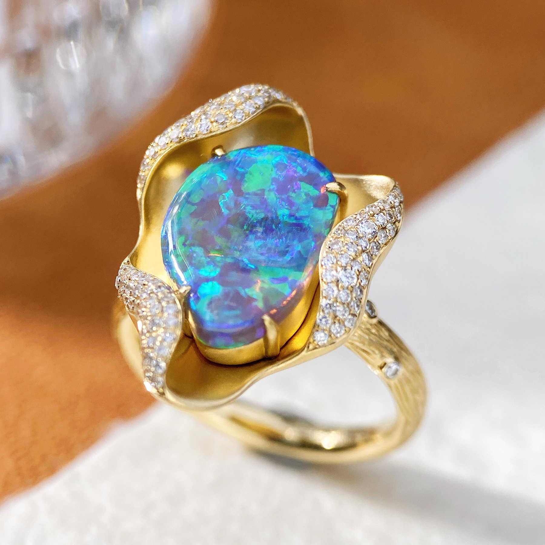 Opal ring photographed on a pale background